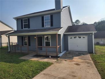 Charming two-story home with a cozy front porch and attached one-car garage at 170 Inverness Trce, Riverdale, GA 30274