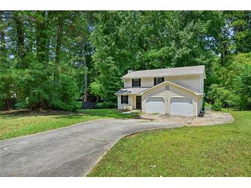 Traditional two-story home with a two-car garage and an expansive front lawn at 1925 Sailcloth St, Lithonia, GA 30058