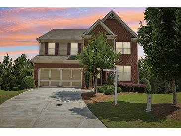 Charming two-story brick home with a well-manicured lawn and a two-car garage at 4480 Egret Ave, Cumming, GA 30041