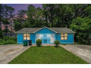 Charming light blue duplex with well-maintained lawn and wooded surroundings at 2480 Washington Street Ext # 2482, Austell, GA 30106