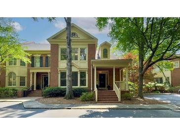 Charming brick townhome with a covered porch and landscaped front yard in a desirable neighborhood at 2010 Riverside Rd, Roswell, GA 30076