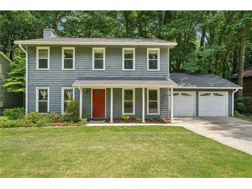 Charming two-story home features a well-manicured lawn, complemented by a covered entryway and a two-car garage at 4772 Ridgewood Nw Ct, Acworth, GA 30102