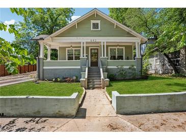 Charming green craftsman-style home with manicured front lawn and inviting front porch at 642 Erin Sw Ave, Atlanta, GA 30310