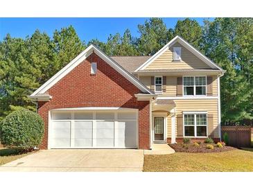 Charming home featuring a brick facade, neutral siding, well-manicured landscaping, and an attached two-car garage at 125 Redsage Rdg, Atlanta, GA 30349