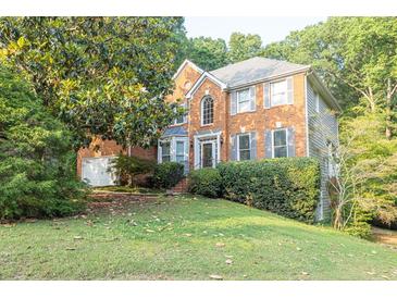 Charming two-story brick home featuring well-maintained landscaping and a welcoming front entrance at 1253 Rivermark Ct, Lawrenceville, GA 30043