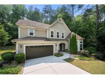 Charming two-story home with a two-car garage and well-manicured landscaping at 2740 Creekside Manor Dr, Powder Springs, GA 30127