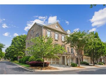 Charming brick townhouse with attached two car garage and manicured landscaping at 11259 Calypso Dr, Alpharetta, GA 30009