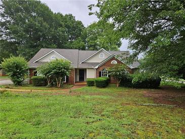 Charming single-story home featuring a brick facade and mature landscaping at 3502 Tiffany Se Dr, Conyers, GA 30013