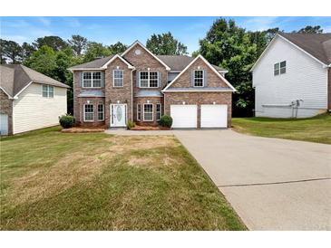 Charming two-story brick home featuring a two-car garage and a well-manicured front lawn at 3517 Mortons Landing Dr, Ellenwood, GA 30294