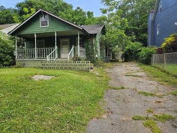 Charming single-Gathering home featuring a cozy front porch and lush greenery at 658 Schuyler Se Ave, Atlanta, GA 30312