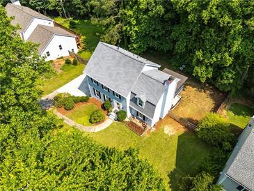 Inviting two-story home with a pristine lawn, mature trees, and a charming walkway enhancing the curb appeal at 1428 Brookcliff Dr, Marietta, GA 30062