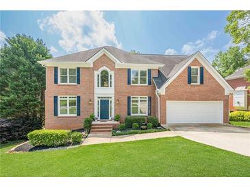 Beautiful two-story brick home with well-manicured lawn and attached two car garage at 1765 Pinetree Pass Lane Southwest Sw Ln, Lilburn, GA 30047