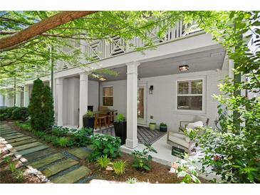 Relaxing back porch with seating, outdoor dining, and decorative plants at 420 Banbury Xing, Alpharetta, GA 30009