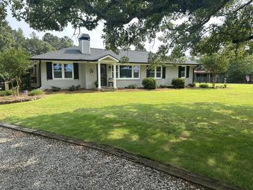 Charming brick home with a well-manicured lawn and mature trees offers great curb appeal at , Social Circle, GA 30025