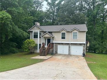 Charming two-story home features a well-maintained lawn and an attached two-car garage at 3951 Mcgill Dr, Decatur, GA 30034