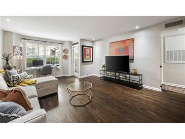 Bright living room featuring hardwood floors, modern furniture, and an adjacent office nook at 3063 Chastain Park Ne Ct, Atlanta, GA 30342