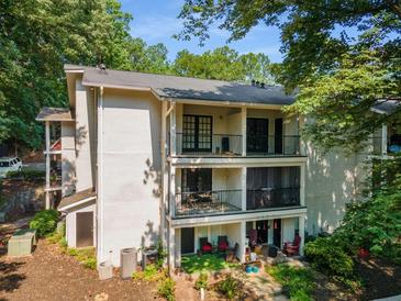 Three-story condo building featuring balconies with black metal railings and lush surrounding greenery at 1150 Collier Nw Rd # L14, Atlanta, GA 30318