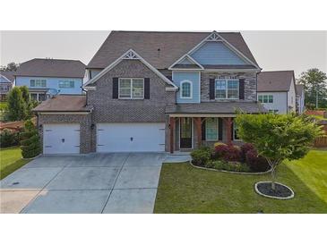 Charming two-story home featuring a brick and stone facade, a two-car garage, and a well-manicured front yard at 2029 Havenhurst Way, Auburn, GA 30011