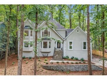 Charming home with beautiful landscaping, stone accents, and mature trees at 1183 Woods Ne Cir, Atlanta, GA 30324