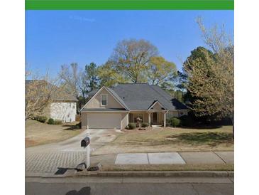 Charming one-story home with mature trees, attached garage, and well-maintained landscaping at 222 Yardsley Dr, Mcdonough, GA 30253