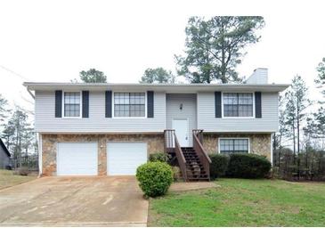 Charming split-level home featuring stone accents, two-car garage and a welcoming entrance staircase at 3674 Riverchase Ter, Decatur, GA 30034