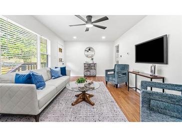 Bright living room with hardwood floors, modern furniture, and a large window at 801 N Evelyn Nw, Atlanta, GA 30318