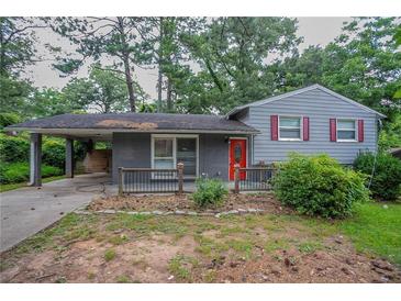 Charming single-Gathering home with a carport and red front door and gray trim at 2475 Harvel Nw Dr, Atlanta, GA 30318