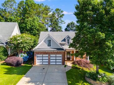 Charming brick-and-siding home with well-manicured landscaping, and a two-car garage at 81 Richmond Way, Villa Rica, GA 30180