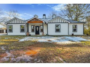 Charming renovated one-story home with a black and white exterior and a wood-framed front porch at 2711 Mcdonough Rd, Hampton, GA 30228