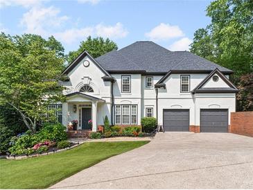 Charming two-story home with a well-manicured lawn and a spacious two-car garage at 3803 Upland Dr, Marietta, GA 30066