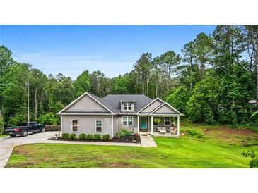 Charming single-story home featuring a covered front porch and lush landscaping at 190 Paul Aiken Rd, Dallas, GA 30157