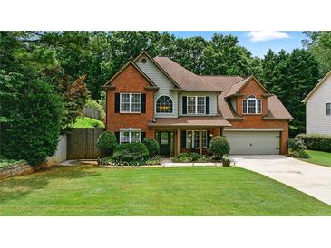 Charming two-story brick home with a well-manicured lawn and inviting curb appeal at 1925 Waters Ferry Dr, Lawrenceville, GA 30043