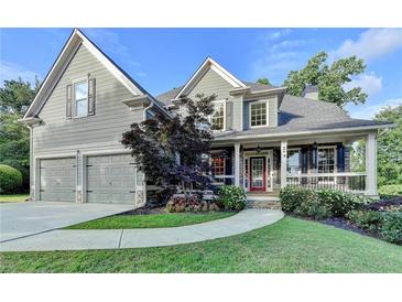 Charming two-story home with a manicured lawn, two-car garage, and inviting front porch at 306 Mill Rdg, Canton, GA 30114