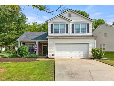 Charming two-story home features a well-manicured lawn and attached two-car garage at 1612 Silver Oak Dr, Austell, GA 30106