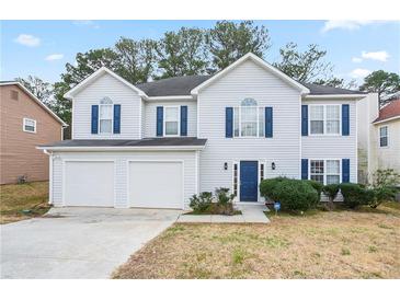 Charming two-story home features a two-car garage and well-maintained landscaping at 2682 Field Spring Dr, Lithonia, GA 30058