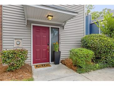 Charming front entrance with a vibrant red door and well-manicured landscaping at 812 Dixie Ne Ave, Atlanta, GA 30307