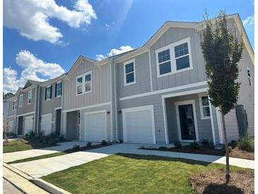 Charming townhomes feature attached garages, well-manicured lawns, and attractive color schemes at 307 Winton Way, Villa Rica, GA 30180