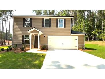 Charming two-story home with a fresh lawn and convenient two-car garage at 45 Emerald Ln, Covington, GA 30014