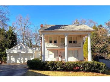 Charming two-story home with classic columns and a two-car garage in the back at 1242 Star Ne Dr, Brookhaven, GA 30319