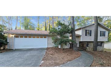 Charming home featuring a two-car garage, classic siding and a cozy front porch at 3226 Bruckner Blvd, Snellville, GA 30078