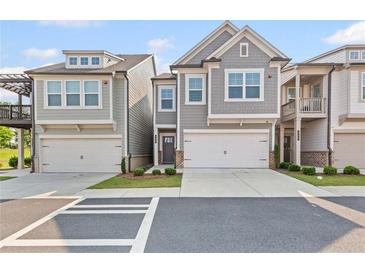Charming townhome featuring an attached garage and craftsman style architectural details at 323 Hayden Circle Cir, Woodstock, GA 30189