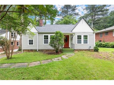 Charming single-story home with landscaped yard and a classic red front door at 1098 Cascade Sw Cir, Atlanta, GA 30311