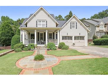 Charming two-story home with a covered front porch, manicured lawn, and two-car garage, perfect for suburban living at 515 Saint Barbaras Nw Ln, Marietta, GA 30064