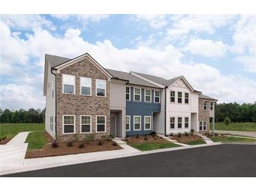 Charming townhomes featuring a mix of brick and siding, enhancing curb appeal and architectural detail at 4428 Ryan St, Douglasville, GA 30135