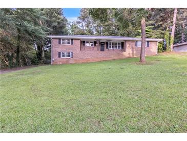 Charming brick home with well-manicured lawn and mature trees at 6243 David Sw Ln, Mableton, GA 30126