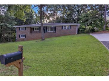 Charming brick home featuring a well-manicured lawn and a classic mailbox at 6243 David Sw Ln, Mableton, GA 30126