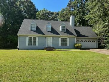 Charming single-Gathering home featuring a well-manicured lawn and attached two car garage at 1481 Yates Cv, Lawrenceville, GA 30043