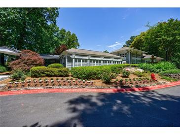 Inviting clubhouse with meticulously landscaped grounds, including flowers and shrubs at 215 Summit North Ne Dr, Atlanta, GA 30324
