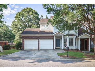 Charming townhome with a two-car garage and a well-manicured lawn at 2594 Laurel Nw Cir, Atlanta, GA 30311
