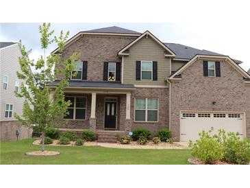 Charming two-story brick home with a well-manicured lawn and inviting front porch at 150 Canal St, Hampton, GA 30228